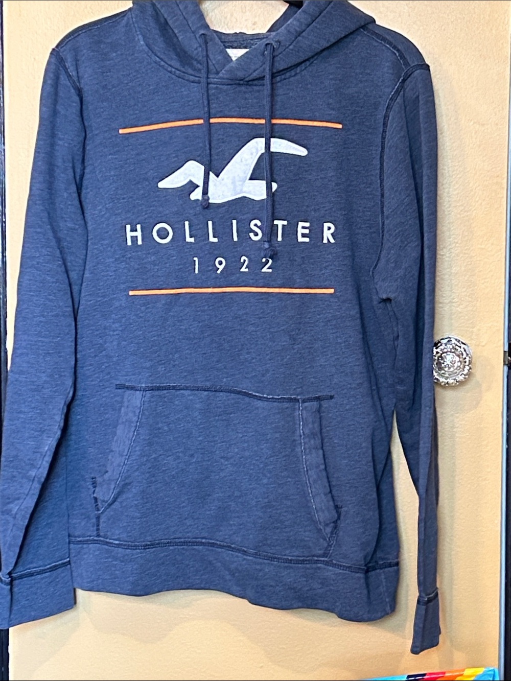 Hollister Navy Blue Pullover Hoodie with White Logo and Orange Accents